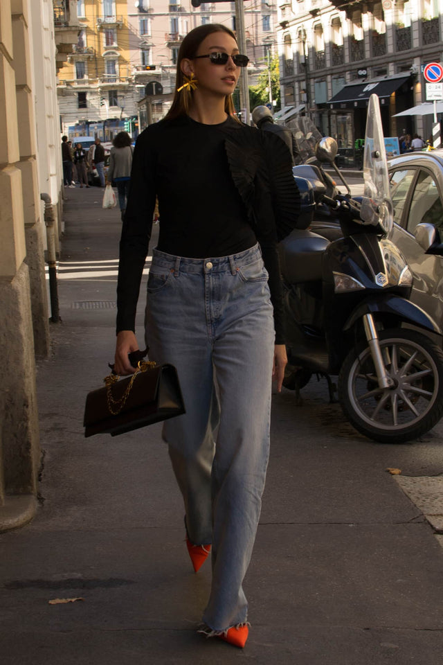 Model in long sleeve ruffle bodysuit