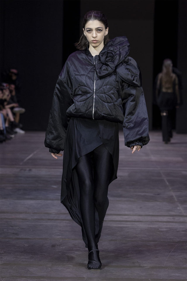 Model in short insulated bomber jacket with a 3d flower