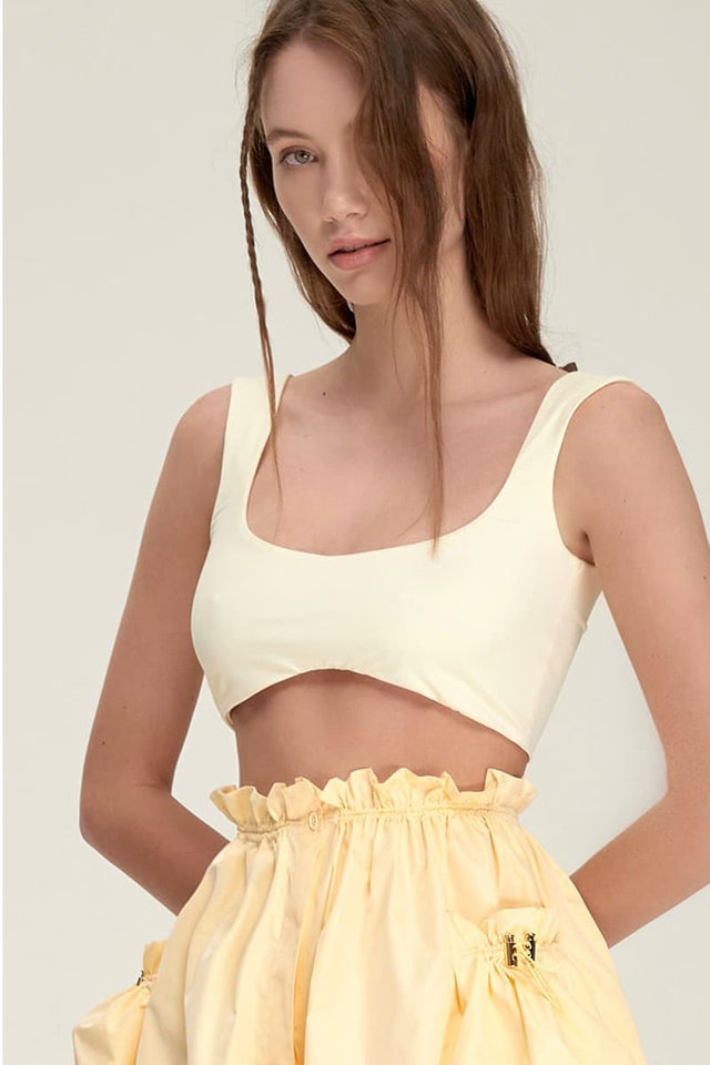 Model in yellow Tank top