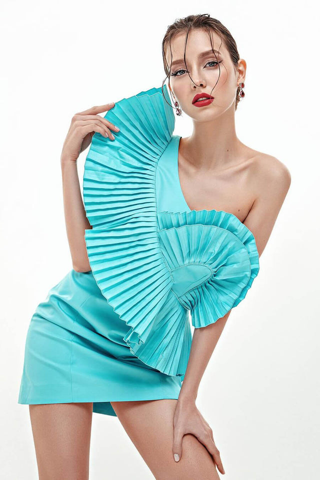 Model in turquoise Asymmetric pleated dress front view