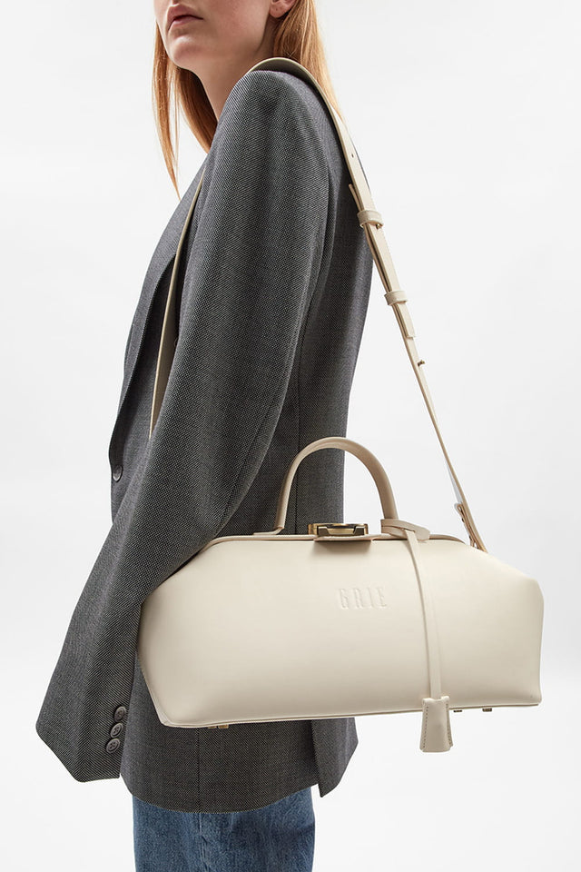 Model with Baguette ivory bag