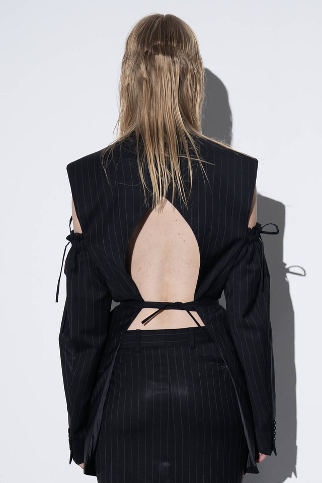 Model in black stripes jacket back view